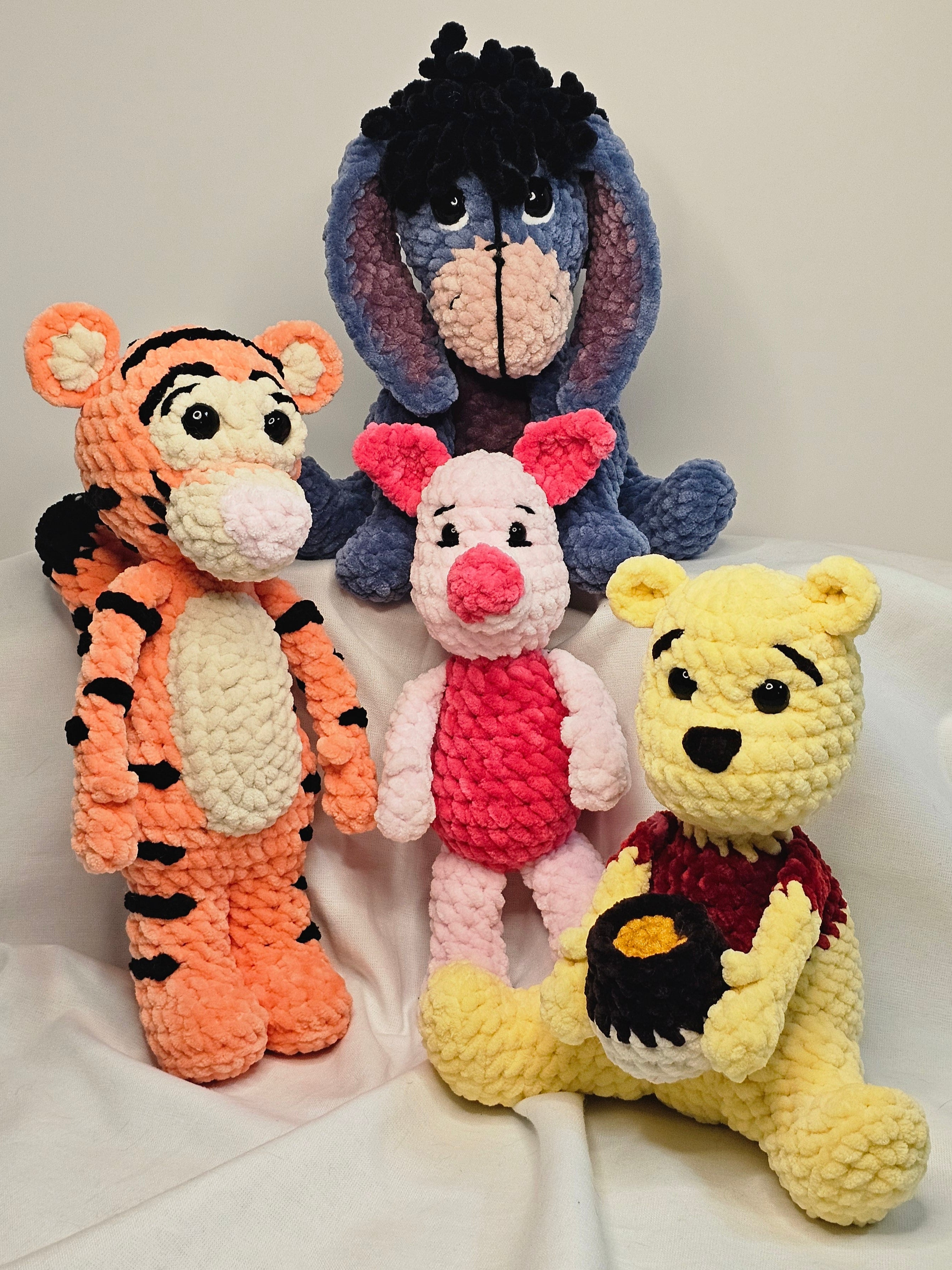 Collection of colorful crochet toys on a white surface
